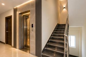 a staircase in a building with a lobby at Hotel Elite kukatpally Near Nexus Mall in Hyderabad