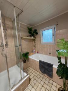 a bathroom with a bath tub and a shower at The Cottages - Pet Friendly in Meißendorf +67 photos