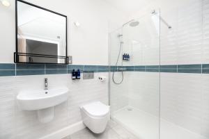 a bathroom with a sink and a toilet and a shower at Shore Hotel in Balintore +22 photos