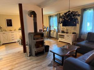 a living room with a wood stove in it at The Cottages - Pet Friendly in Meißendorf
