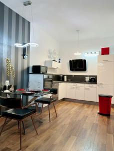 a kitchen and dining room with a table and chairs at High Level Apartment in Mannheim