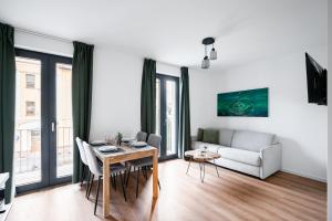 a living room with a table and a couch at Apartmány Perninský Dvůr in Pernink