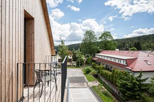 an outdoor balcony with a view of a building at Apartmány Perninský Dvůr in Pernink