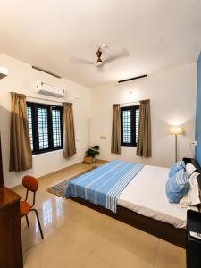 a bedroom with a large bed in a room at Aurena Stays Varkala in Varkala