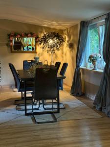 a dining room with a table and chairs at The Cottages - Pet Friendly in Meißendorf
