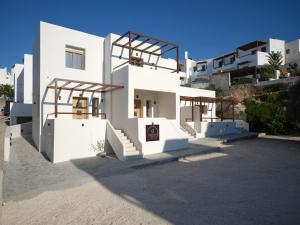 a white house with stairs on the side of it at Rocaia Mini Suites Naousa in Naousa