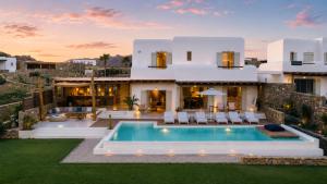 a villa with a swimming pool in front of a house at Villa RED VENUS in Kalafatis