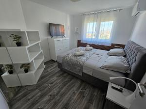 a bedroom with a large bed and a dresser at Villa Rocco Private Saltwater Pool Split in Kaštela +75 photos