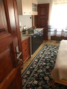 a kitchen with a stove and a rug on the floor at Penzion Trstená in Trstená
