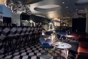 a bar with blue chairs and tables in a room at Vander Urbani Resort - a Member of Design Hotels in Ljubljana