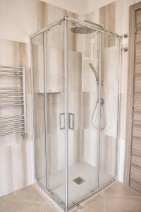 a shower with a glass enclosure in a bathroom at Merus in Faicchio