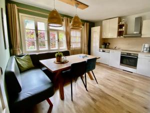 a kitchen and dining room with a table and chairs at Villa Zeppelin - App Bergkristall in Bramberg am Wildkogel