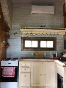 a kitchen with a stove and a window at Chaloupka Bečov in Blatno