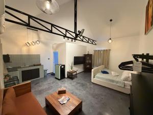 a living room with a couch and a tv at Blue Privacy Resort in Nathon Bay