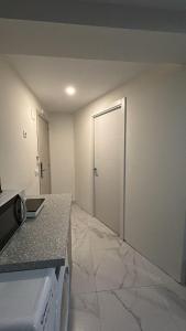 an empty room with a door in a room at SIMPL hostel Oquendo in Madrid