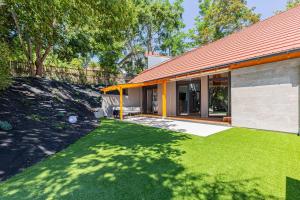 a house with a lawn in front of it at Elite House Platina Apartment in Leányfalu