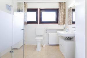 a bathroom with a toilet and a sink at Küsten Auszeit in Guttau +18 photos