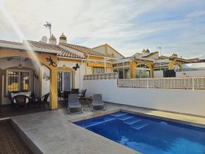 a house with a swimming pool in the backyard at Bluemoon in Mazarrón