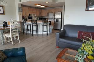 a living room and kitchen with a couch and a table at River Place Condos #410 3BD in Pigeon Forge