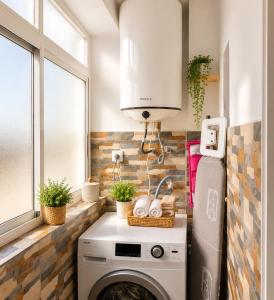 a kitchen with a washer and dryer next to a window at COSTA DE ALMERIA PLAYA in Almería