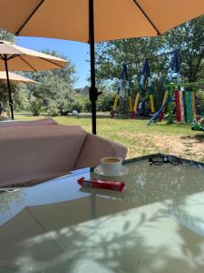 a cup of coffee sitting on a table with an umbrella at Robinson Hotel in Zatoka