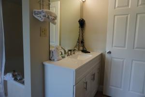 a bathroom with a sink and a mirror at River Place Condos #410 3BD in Pigeon Forge