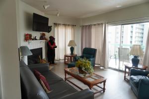 a woman standing in a living room with a fireplace at River Place Condos #410 3BD in Pigeon Forge