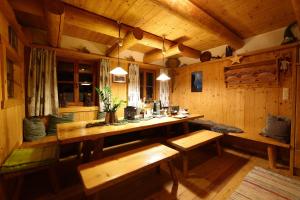 a room with benches and a table in a cabin at Berggasthof Biberg in Saalfelden am Steinernen Meer +55 photos