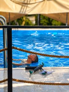 a man in a swimming pool on a rope at Weekend Joy Home Visoko in Visoko +29 photos