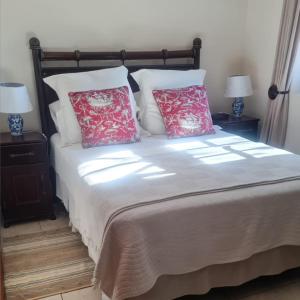 a bedroom with a bed with two pillows on it at Castelo Sutil Guest House in Bloemfontein