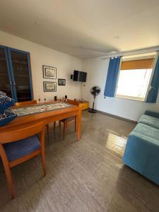 a living room with a table and a couch at Casa vacanze Piedigrotta in Pizzo