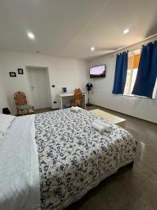a bedroom with a bed with a blue and white comforter at Casa vacanze Piedigrotta in Pizzo