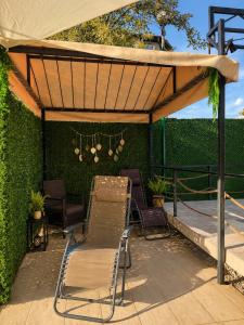 a pergola with chairs and tables under it at Weekend Joy Home Visoko in Visoko