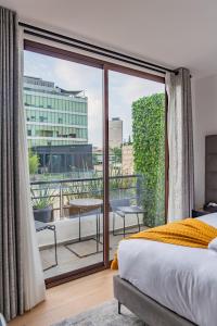 a bedroom with a bed and a large window at Casa Castillo in Mexico City