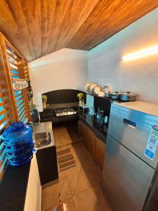 a kitchen with a stainless steel refrigerator and a stove at Chettiparambil Heritage in Cochin +33 photos