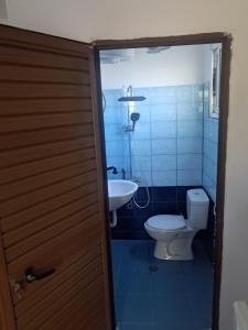 a bathroom with a toilet and a sink at Tonia&Sion in Vlorë