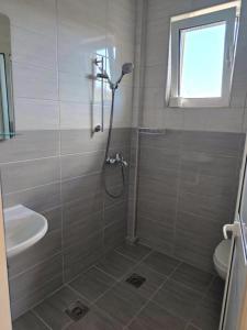 a bathroom with a shower and a sink at Vila Cattleya in Donji Štoj