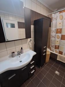 a bathroom with a sink and a mirror and a shower at Little Citrus Yard in Karlovasi +30 photos
