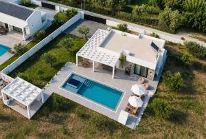 an aerial view of a house with a swimming pool at Lion Exclusive Villa in Sarakinádhon +10 photos