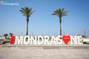 a large sign in front of two palm trees at Dimora C&A in Mondragone