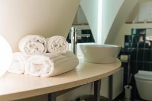 a pile of towels on a counter in a bathroom at La Casa di Nadì in Matera +83 photos