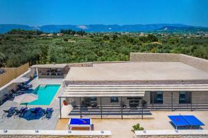 an aerial view of a building with a swimming pool at Villa Casa Liveris by Villa Plus in Akrotiri