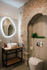 a bathroom with a sink and a toilet at Kallia Castle apartments in Chios