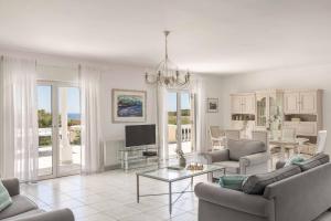 a living room with a couch and a table at Villa Polymnia in Kaligata