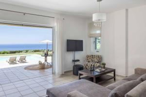 a living room with a view of the ocean at Villa Agnandi in Lakíthra