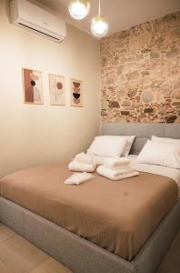 a bedroom with a bed with towels on it at Kallia Castle apartments in Chios