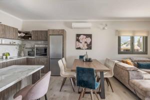 a kitchen and living room with a table and a couch at Casa Bella in Karavádhos