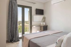 a bedroom with two beds and a large window at Casa Bella in Karavádhos +11 photos