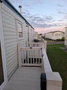 a porch of a mobile home with a deck at Atlas Florida in Ingoldmells