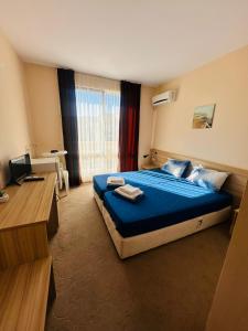 a hotel room with a bed and a desk at Ivian Family Hotel in Ravda +30 photos
